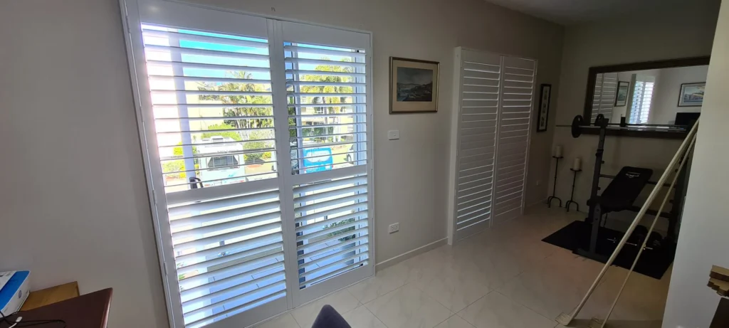 Plantation shutters covering sliding glass door