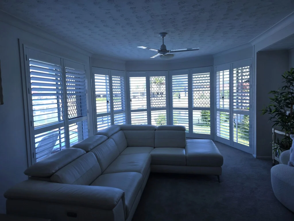 Plantation shutters on the window of the inside living area