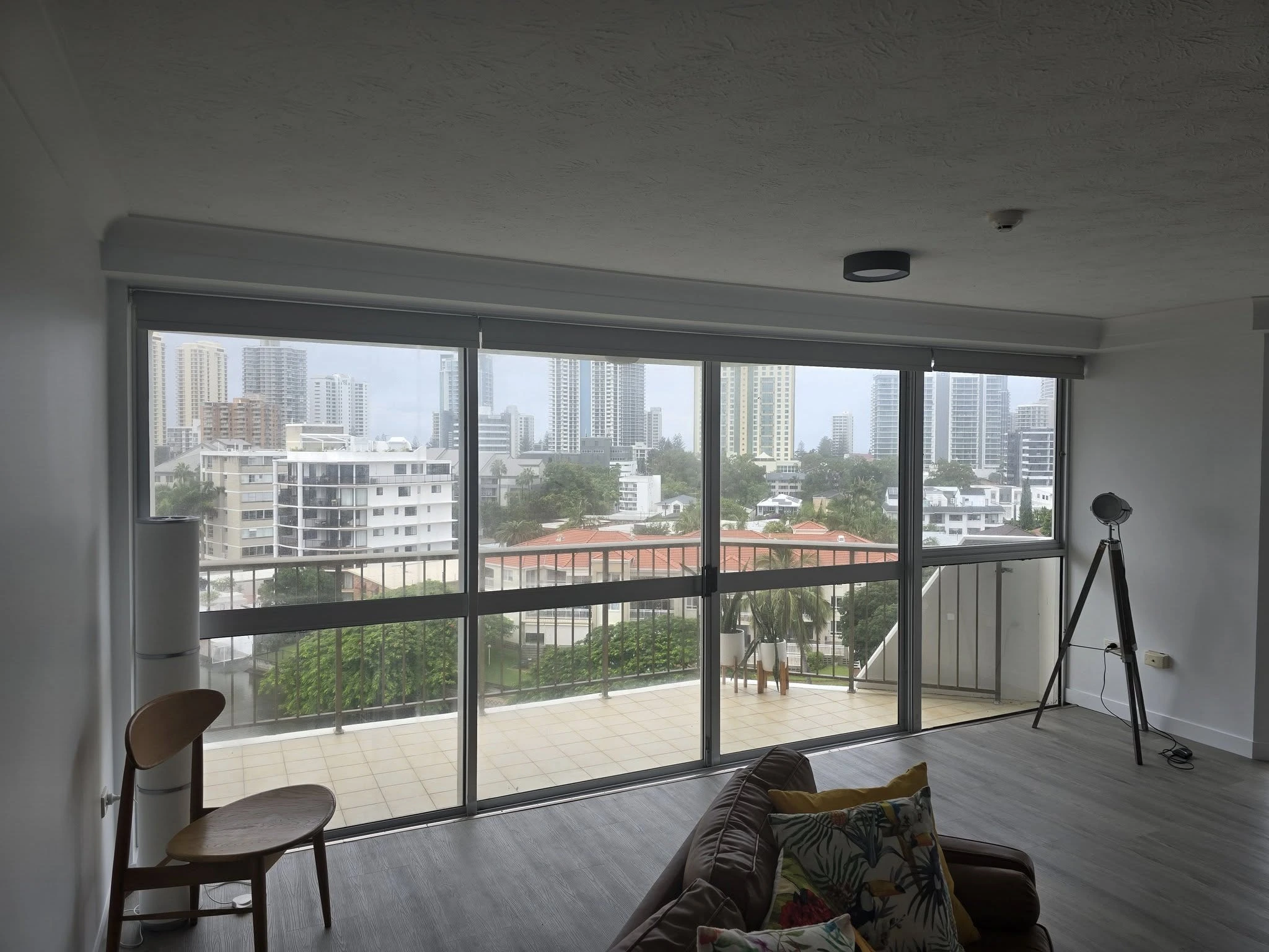 Roller blinds on door with city view in the background