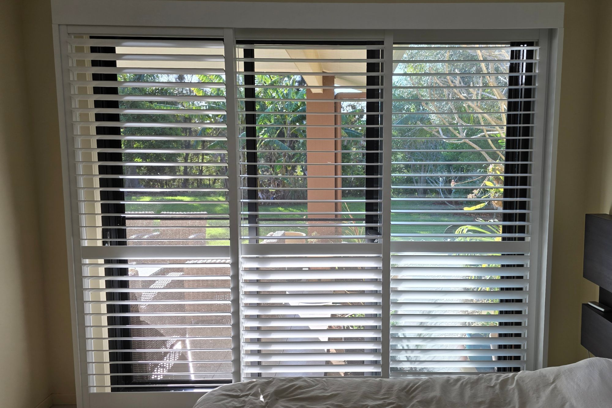 Plantation shutters on bedroom window to outside area