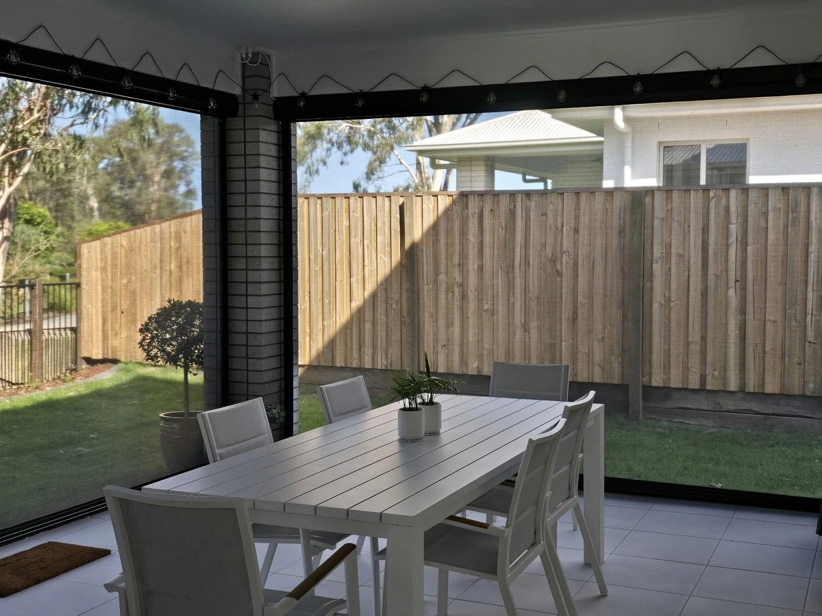 Outdoor patio area with roller blinds