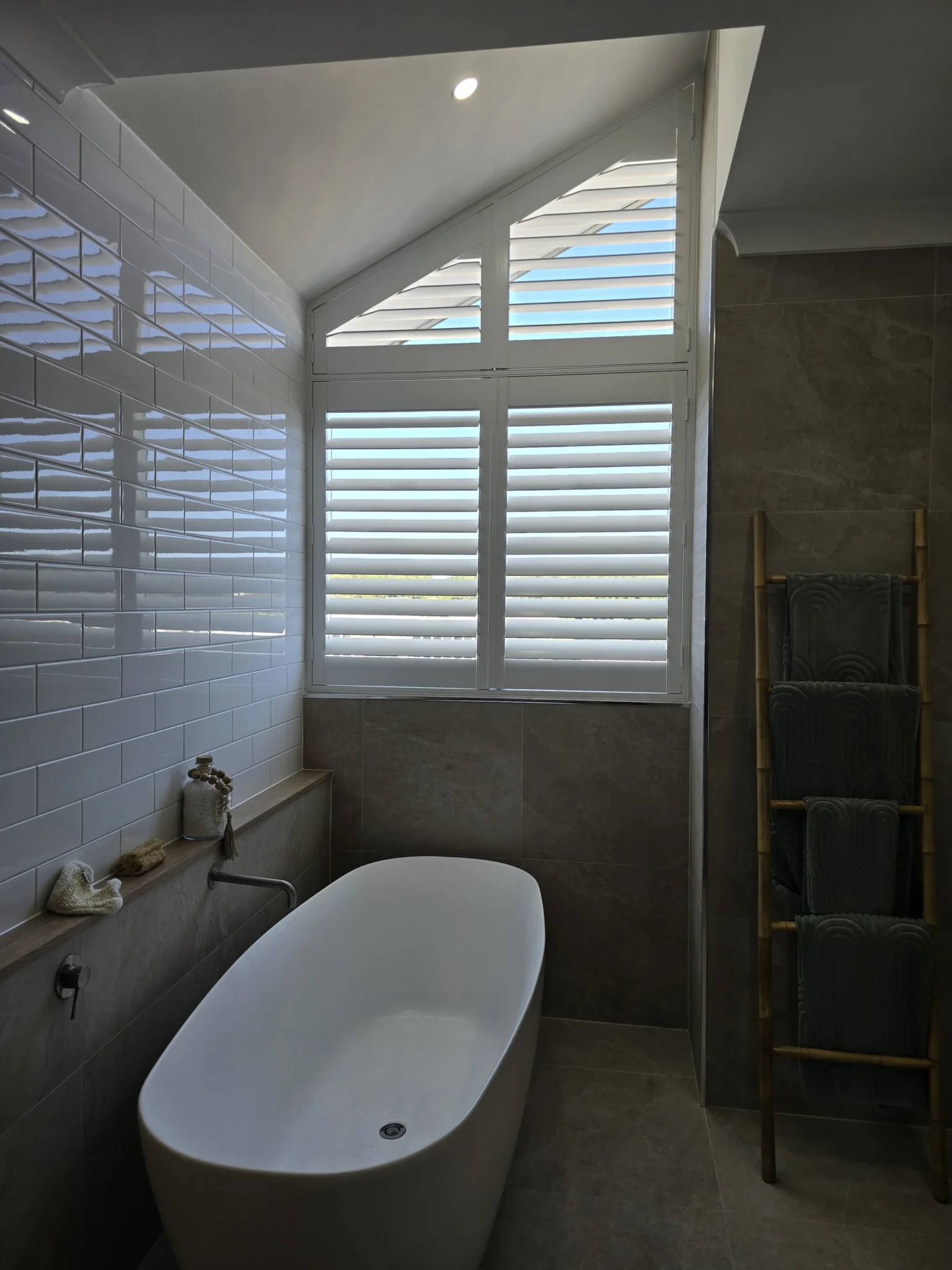 Raked plantation shutters on a modern bathroom