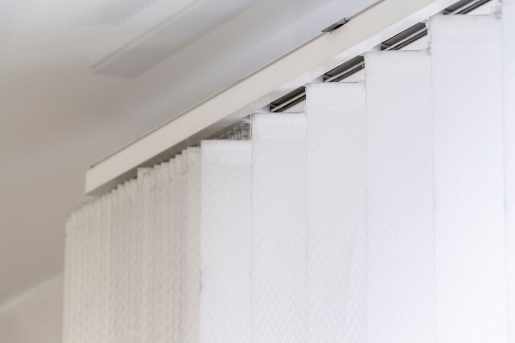 Close up of vertical blinds sliding rail