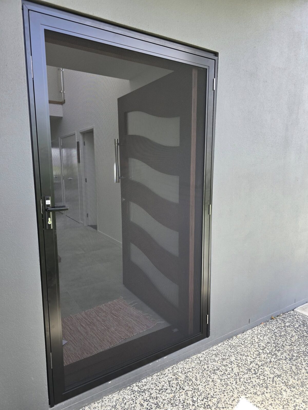 Pivot front door with a customer frame to secure a security screen