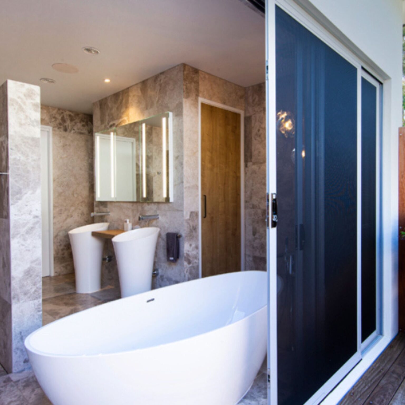 ForceField sliding door on outdoor bathroom