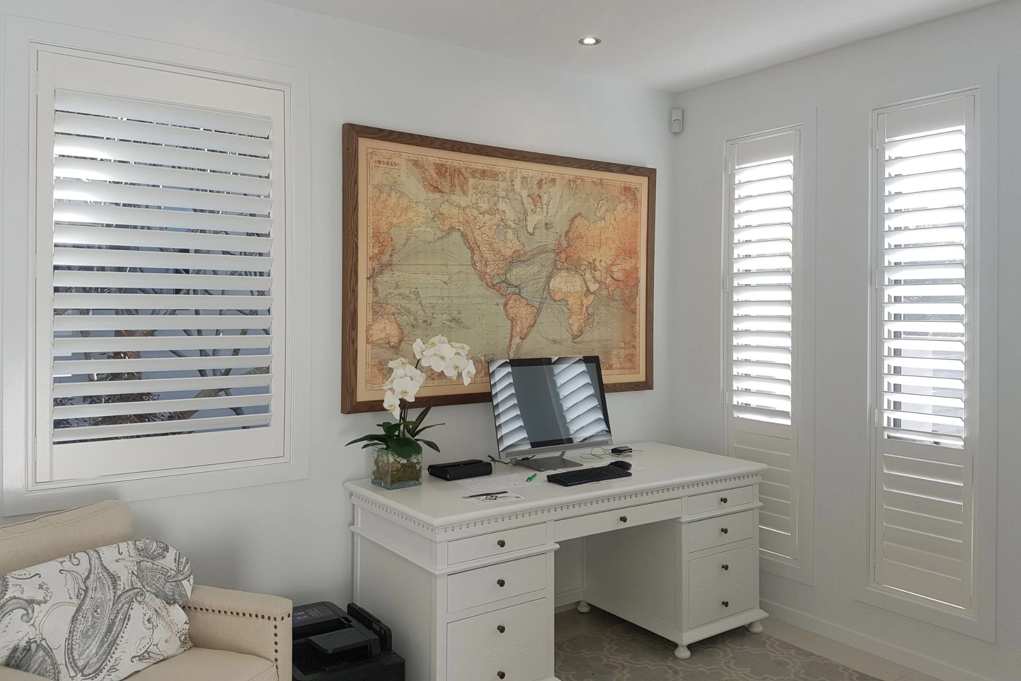 Plantation shutters on the windows of a home office
