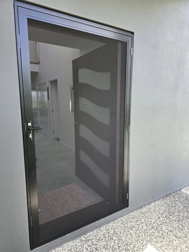 Pivot front door with a customer frame to secure a security screen