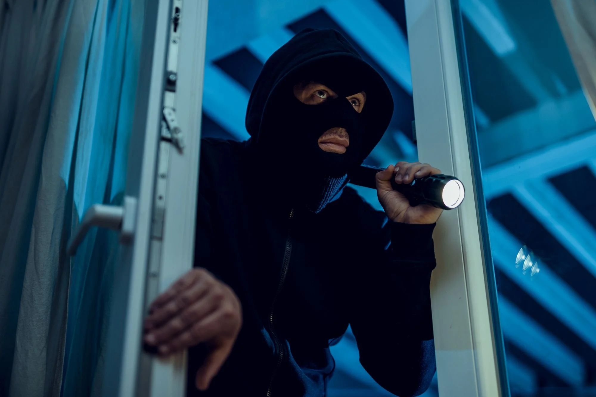 Burgular breaking into a house
